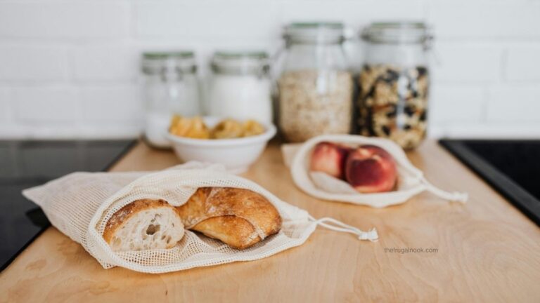 Pantry staples in glass jars with fresh bread in a reusable cloth bag, representing old fashioned frugal living habits